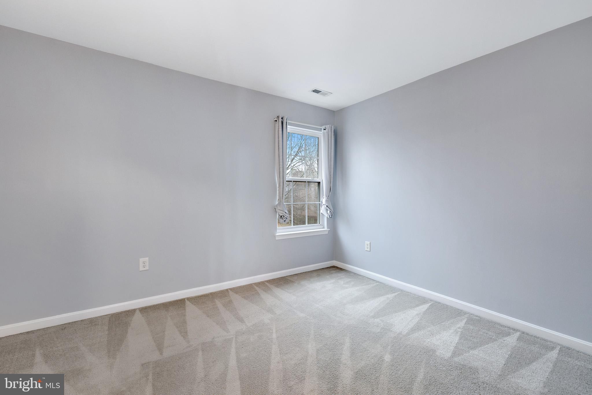 8008 Carlean Court Pasadena, MD 21122 - Photo 20 of 35 a view of an empty room with a window