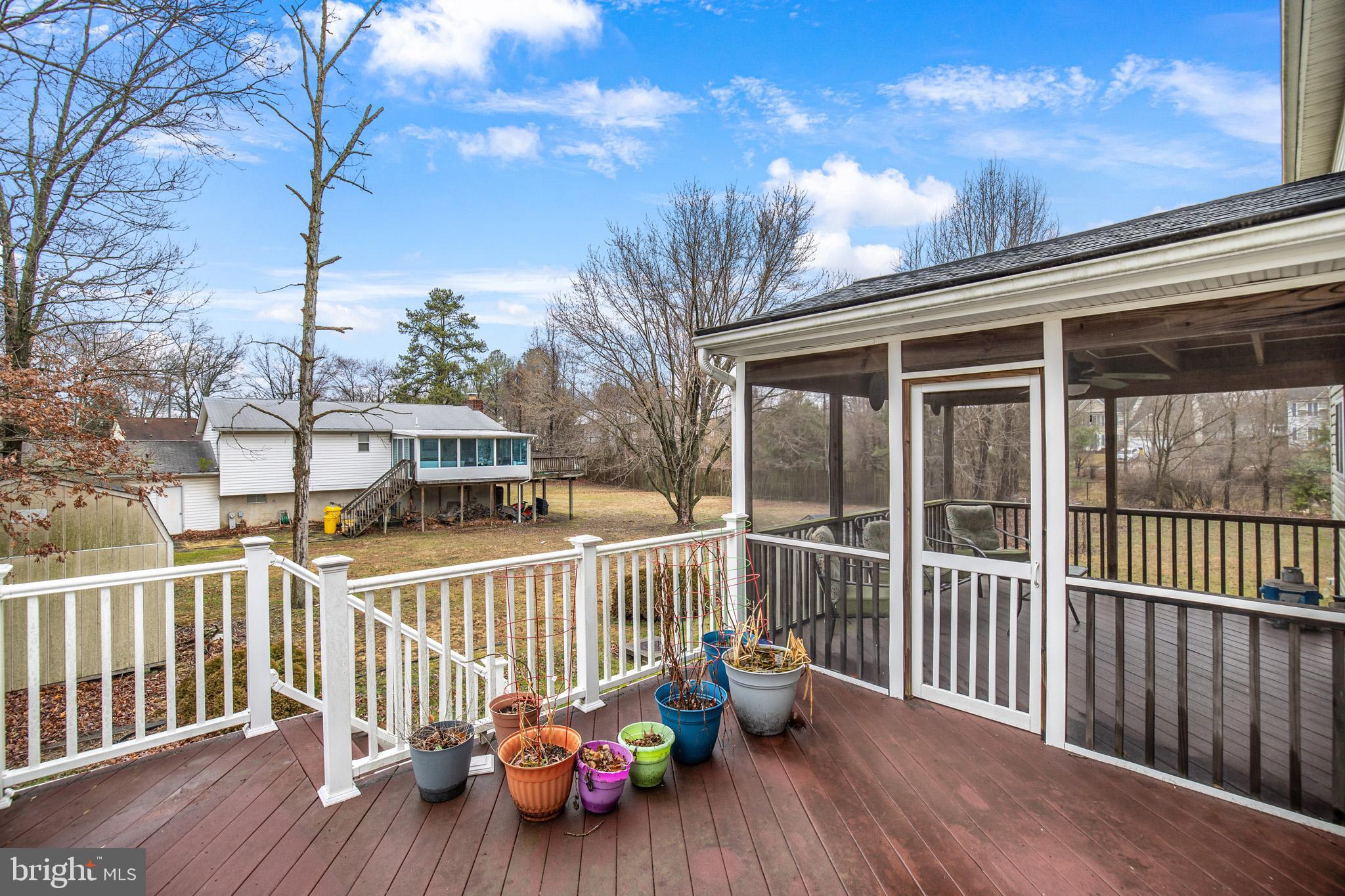8008 Carlean Court Pasadena, MD 21122 - Photo 32 of 35 a view of a deck with two chair and wooden floor
