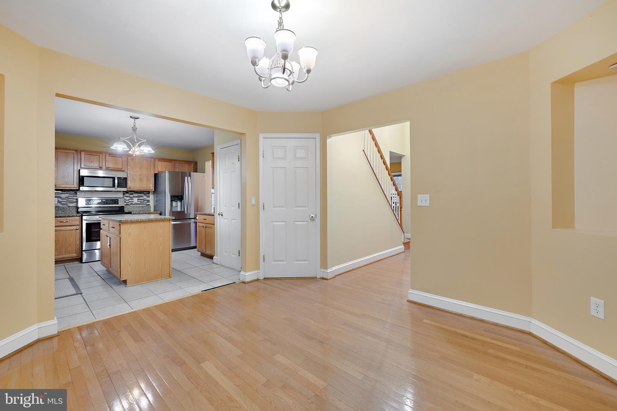 8008 Carlean Court Pasadena, MD 21122 - Photo 10 of 35 a view of kitchen with granite countertop cabinets and refrigerator