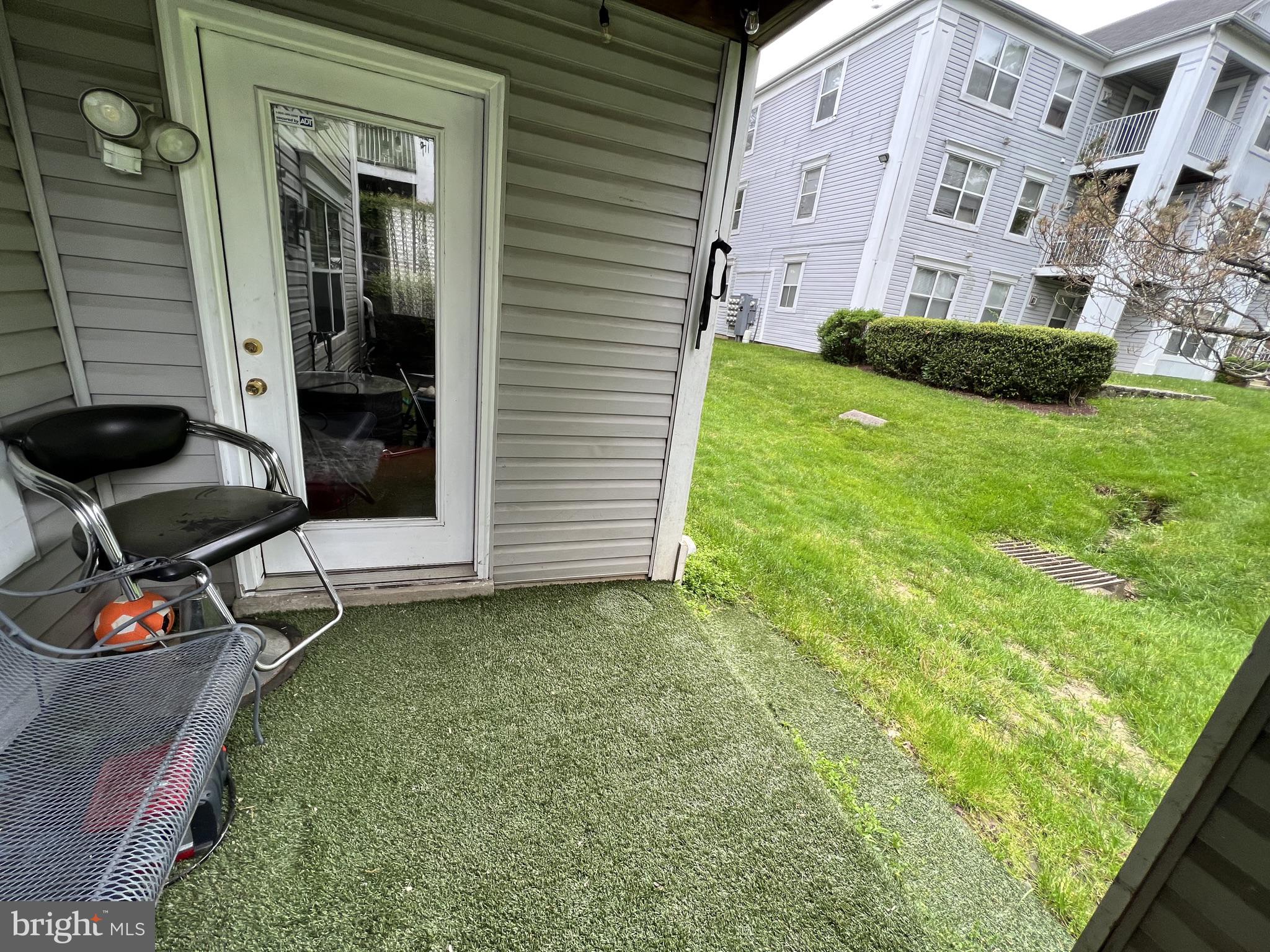 14200 Valleyfield Drive, Unit 437 Silver Spring, MD 20906 - Photo 13 of 17 a view of a patio with a table and chairs