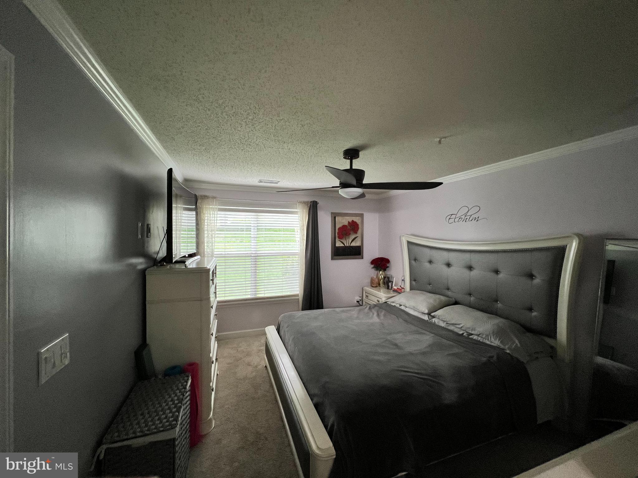 14200 Valleyfield Drive, Unit 437 Silver Spring, MD 20906 - Photo 15 of 17 a bedroom with a bed and a window