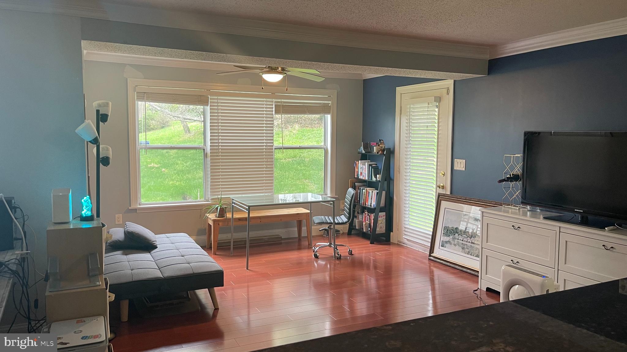 14200 Valleyfield Drive, Unit 437 Silver Spring, MD 20906 - Photo 3 of 17 a living room with furniture and a flat screen tv