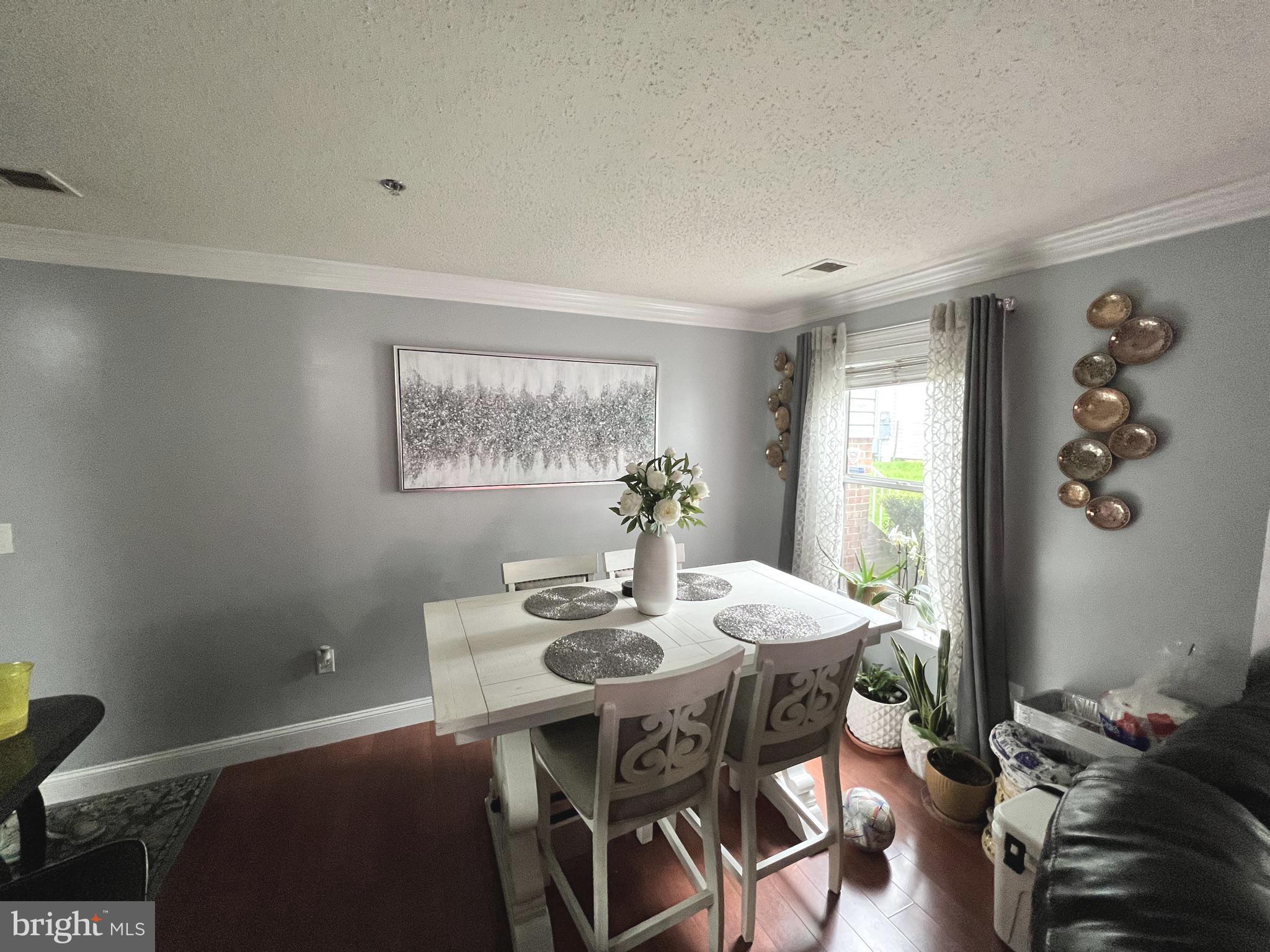 14200 Valleyfield Drive, Unit 437 Silver Spring, MD 20906 - Photo 4 of 17 a view of a dining room with furniture window and wooden floor