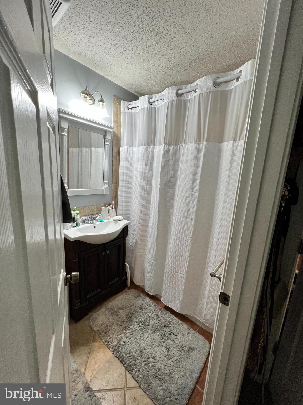 14200 Valleyfield Drive, Unit 437 Silver Spring, MD 20906 - Photo 9 of 17 a bathroom with a sink and a mirror