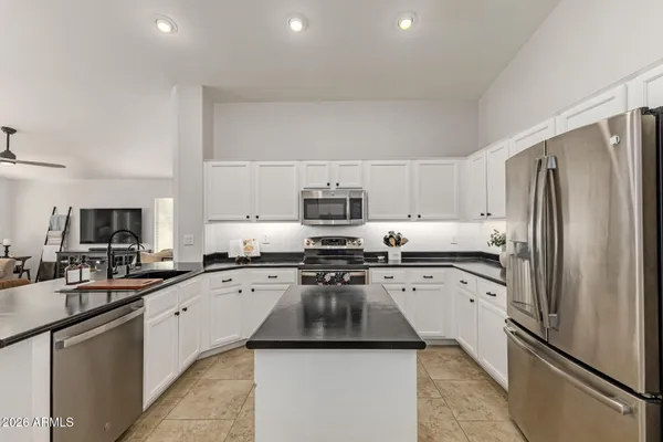 a spacious bedroom with a bed and a chair