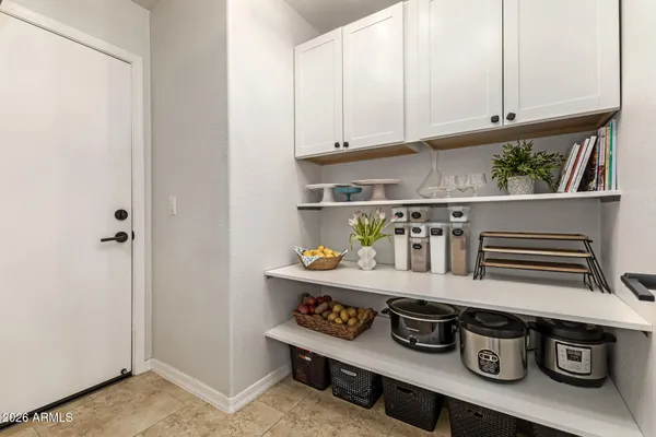 a spacious bedroom with a bed and a ceiling fan