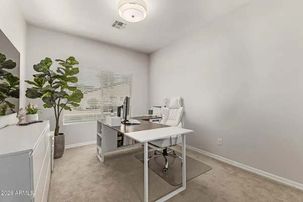 a view of a patio with chairs and a table