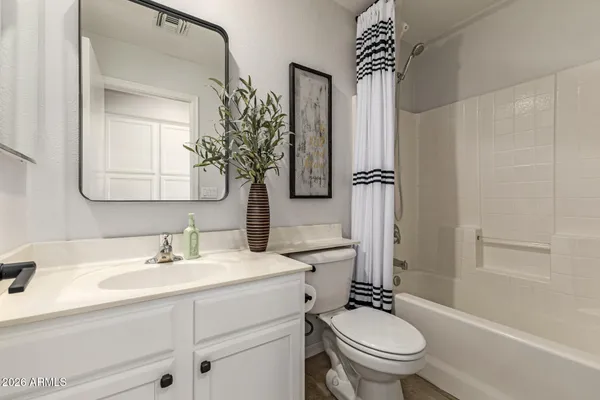 a view of a patio with table and chairs under an umbrella