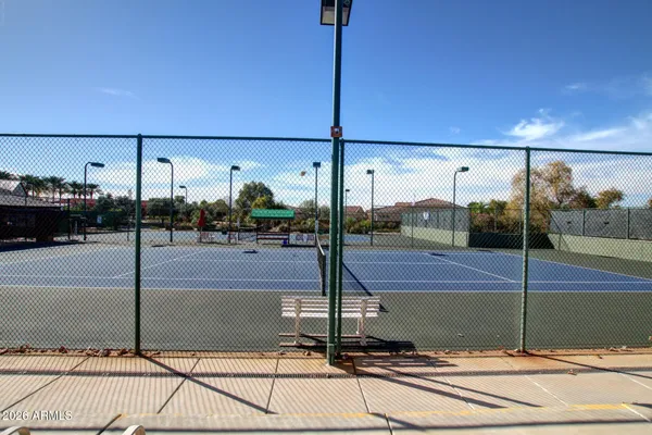 a view of a big house with a big yard and large trees