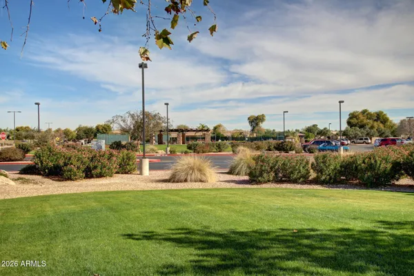 a view of a patio with dining table and chairs under an umbrella