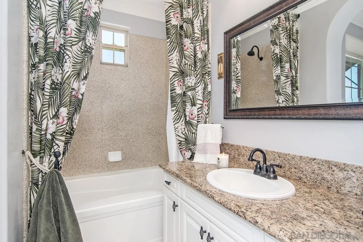 2080 Historic Decatur Road San Diego, CA 92106 - Photo 29 of 47 a bathroom with a granite countertop sink a toilet and a bathtub