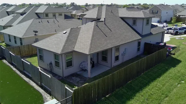 an aerial view of a house with a big yard
