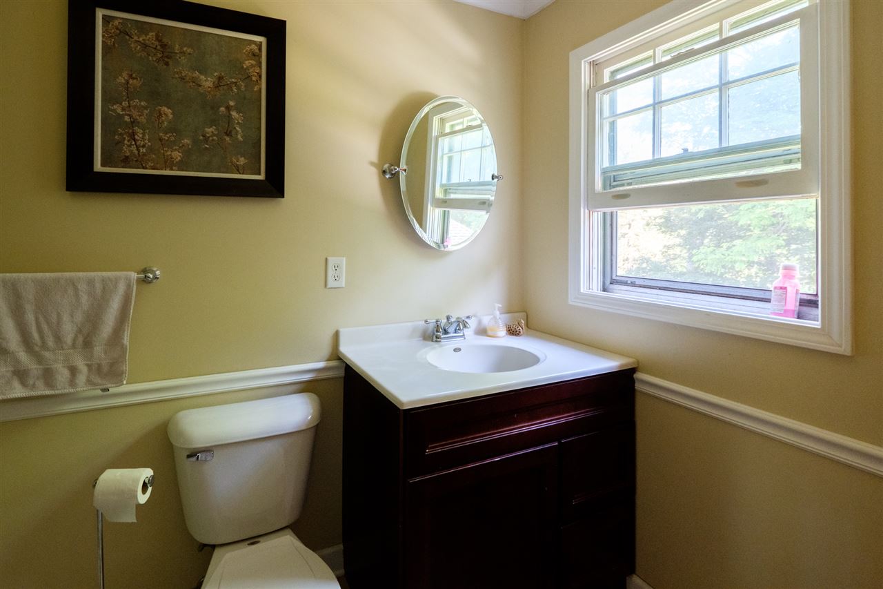 515 South Alpine Road Rockford, IL 61108 - Photo 13 of 25 a bathroom with a toilet a sink and a mirror