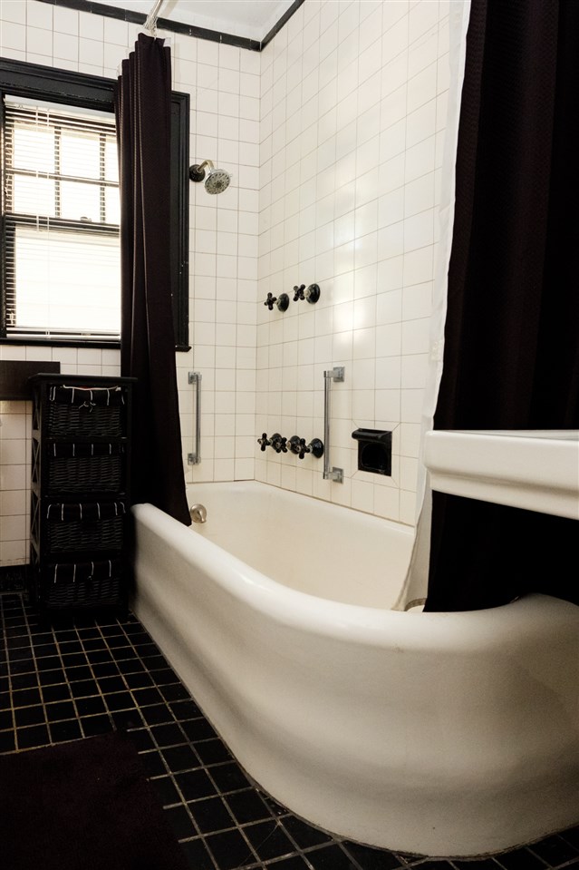 515 South Alpine Road Rockford, IL 61108 - Photo 22 of 25 a white bath tub sitting in a bathroom next to a window