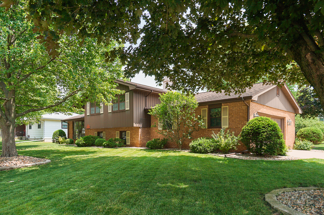 a view of a house with backyard sitting area and garden