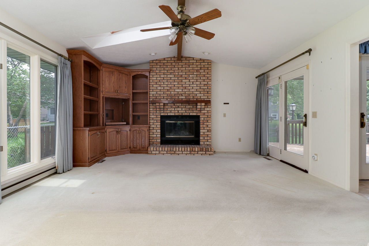 126 South Orr Drive Normal, IL 61761 - Photo 15 of 46 a view of an empty room with a fireplace and a window