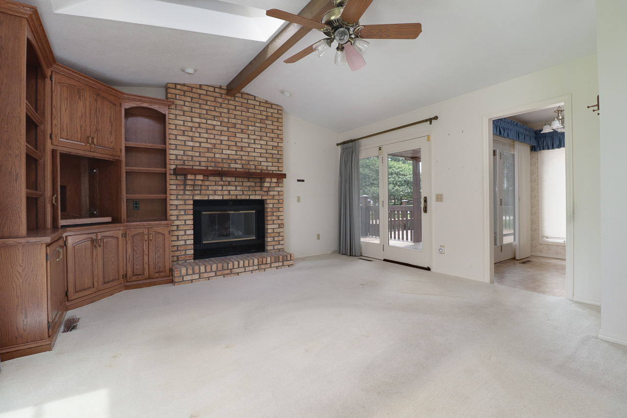 126 South Orr Drive Normal, IL 61761 - Photo 19 of 46 a view of an empty room with a fireplace and a window