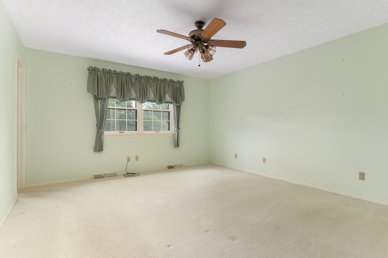 126 South Orr Drive Normal, IL 61761 - Photo 21 of 46 an empty room with a ceiling fan and windows