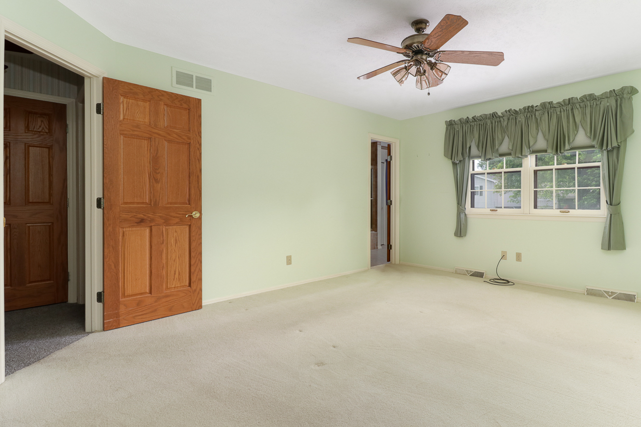 126 South Orr Drive Normal, IL 61761 - Photo 22 of 46 an empty room with chandelier fan and windows