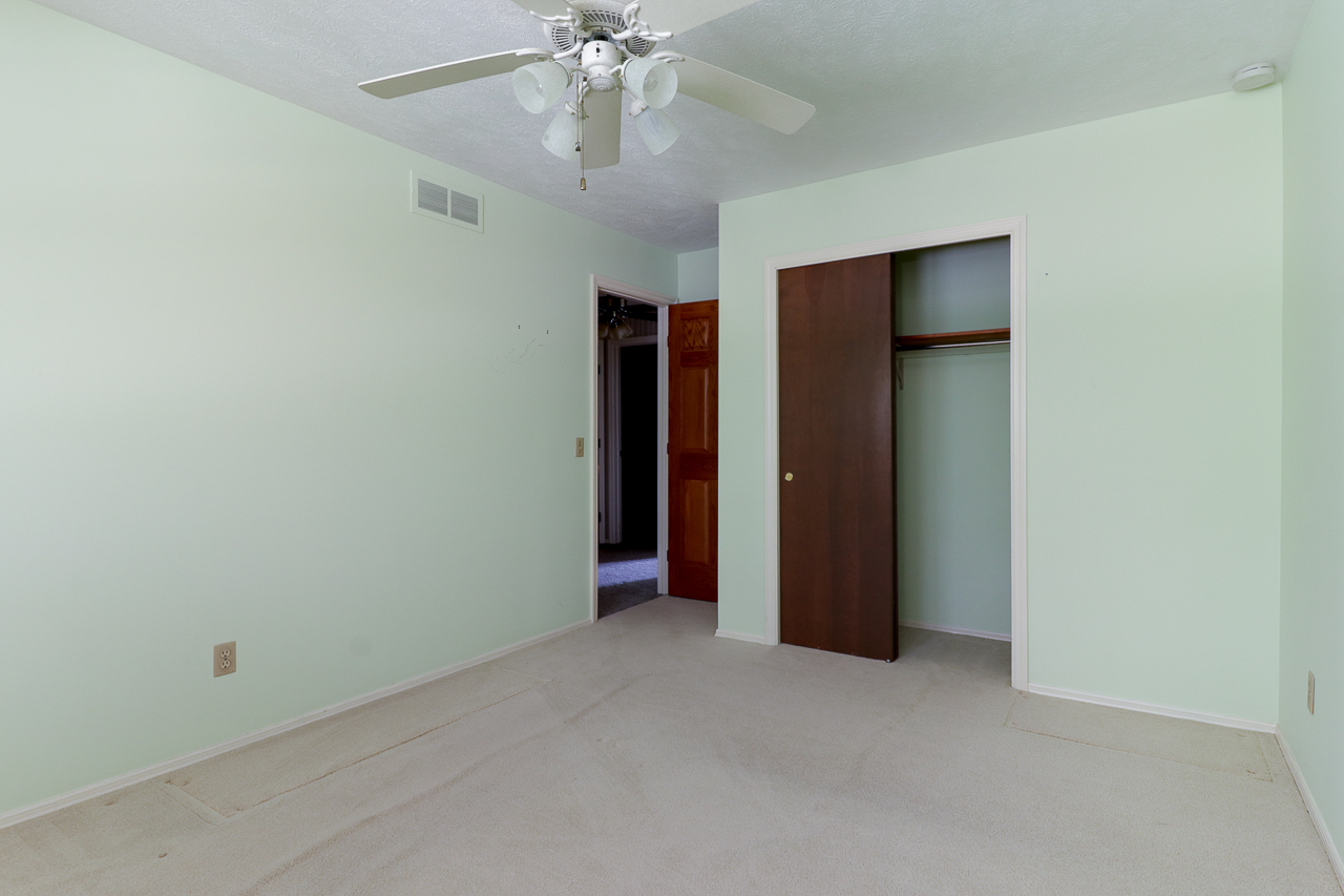 126 South Orr Drive Normal, IL 61761 - Photo 27 of 46 an empty room with closet and a chandelier fan