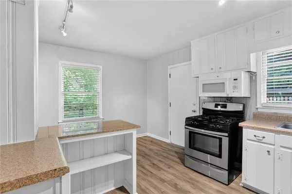 a kitchen with granite countertop a stove and a sink