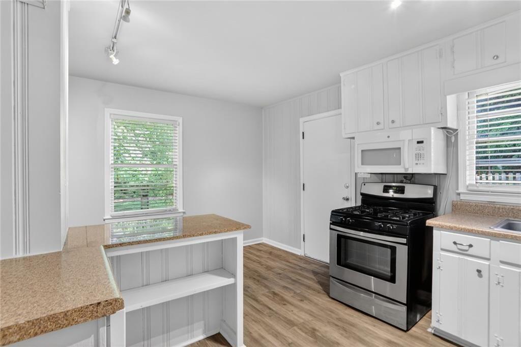 3086 Caldwell Road Northeast Atlanta, GA 30341 - Photo 7 of 11 a kitchen with granite countertop a stove and a sink