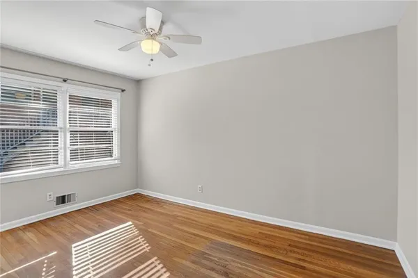 a view of a room with wooden floor and a window