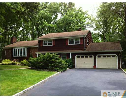 92 George Avenue Edison, NJ 08820 - Photo 1 of 15 a front view of a house with a yard and garage