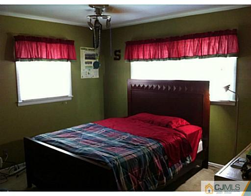 92 George Avenue Edison, NJ 08820 - Photo 11 of 15 a bedroom with a bed and a window