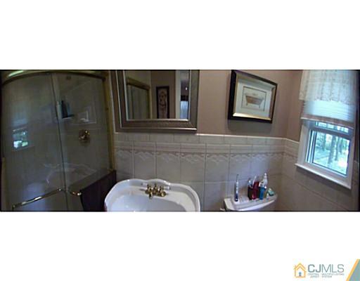 92 George Avenue Edison, NJ 08820 - Photo 12 of 15 a bathroom with a sink and mirror
