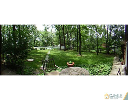 92 George Avenue Edison, NJ 08820 - Photo 14 of 15 a view of a garden with a bench in a park