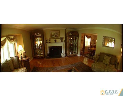 92 George Avenue Edison, NJ 08820 - Photo 4 of 15 a living room with furniture and a fireplace