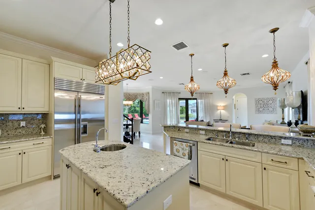 a view of kitchen with kitchen island stainless steel appliances sink stove and microwave