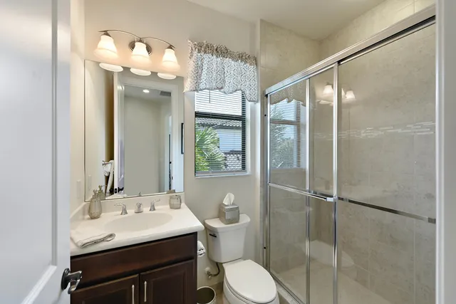 a bathroom with a granite countertop sink toilet and a bathtub