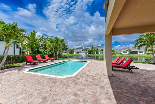 a living room with furniture and floor to ceiling window