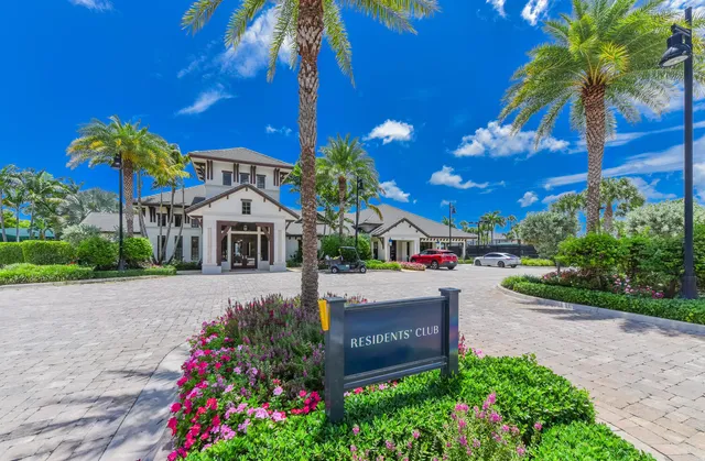 a kitchen with a refrigerator and white cabinets
