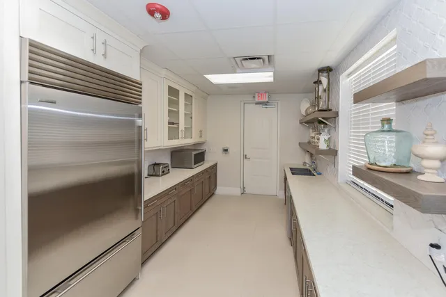 a view of a patio with a table and chairs under an umbrella
