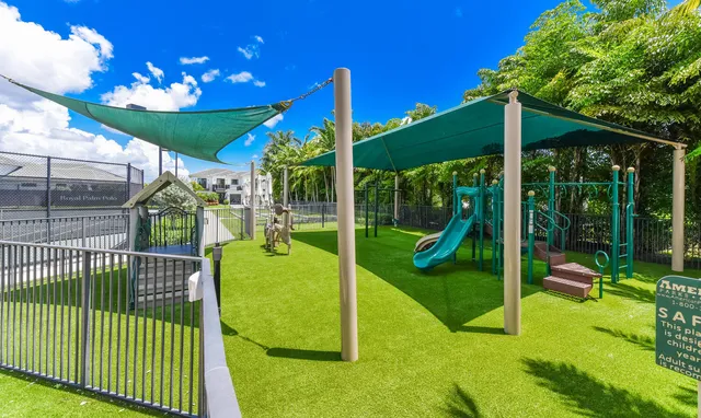 a view of a park with large trees