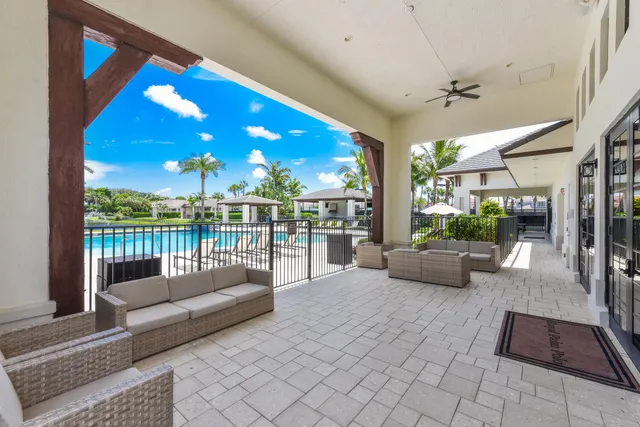 a view of a house with a yard and potted plants