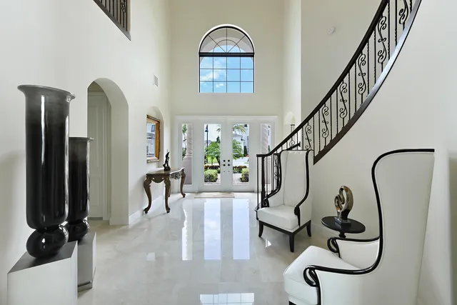 a living room with furniture a fireplace and a large window