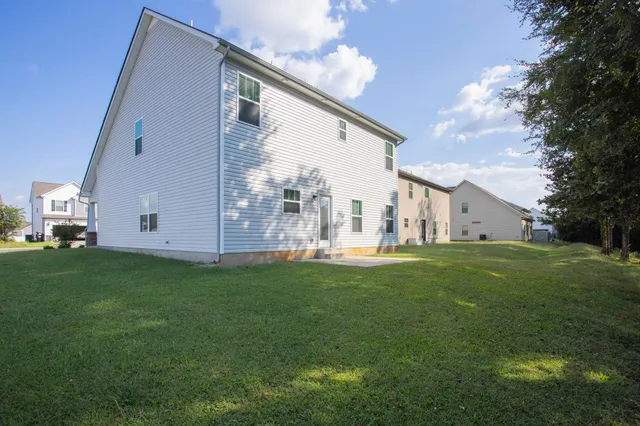 a view of a backyard with swimming pool
