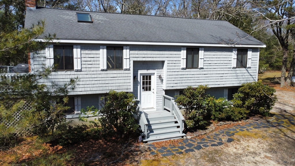 87 Seapit Road, Unit RD Falmouth, MA 02536 - Photo 1 of 21 a front view of a house with a garden