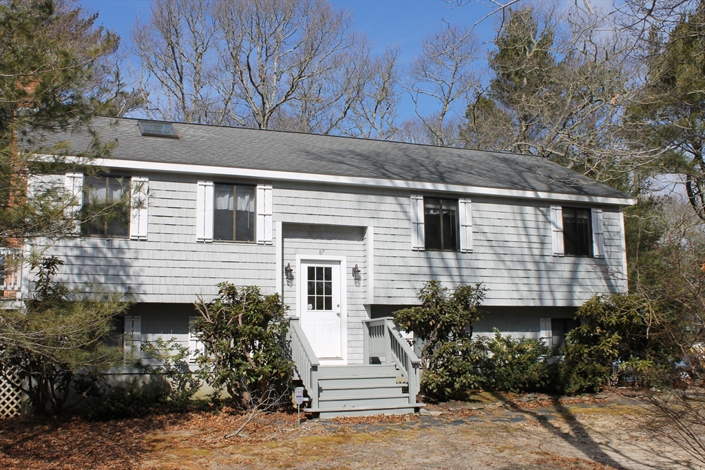 87 Seapit Road, Unit RD Falmouth, MA 02536 - Photo 2 of 21 a front view of a house with a garden