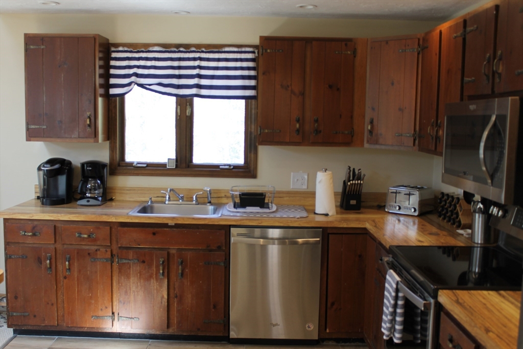 87 Seapit Road, Unit RD Falmouth, MA 02536 - Photo 7 of 21 a kitchen with a sink a stove and cabinets