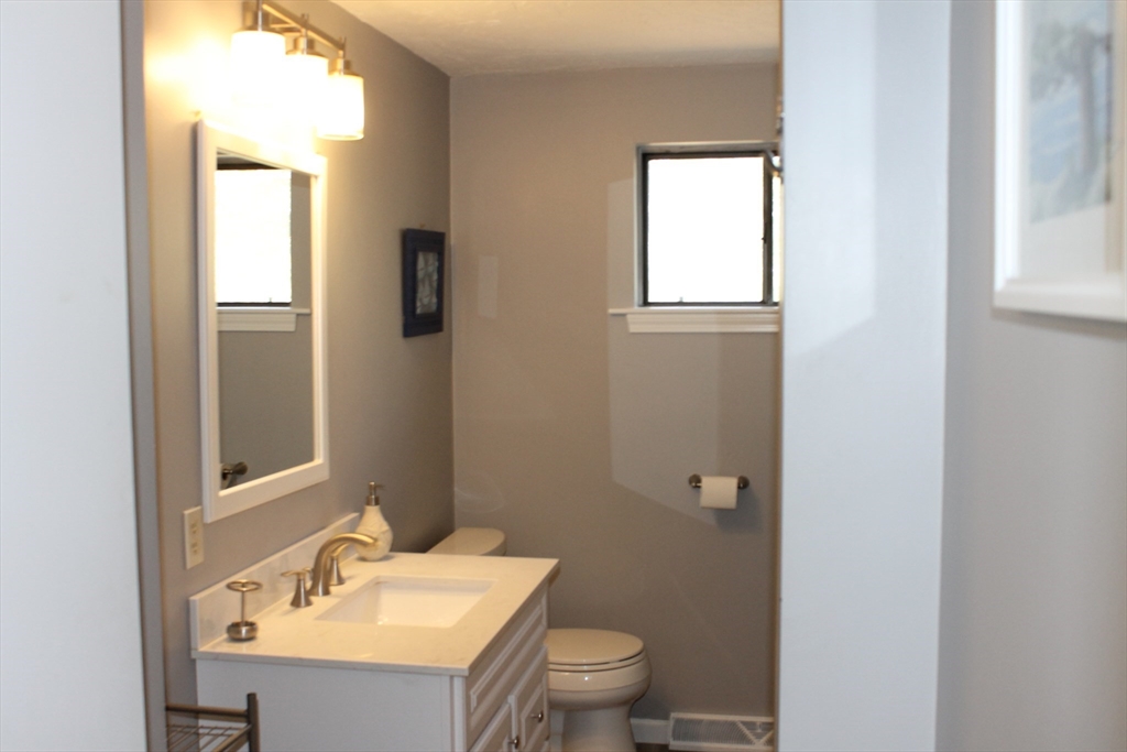 87 Seapit Road, Unit RD Falmouth, MA 02536 - Photo 8 of 21 a bathroom with a sink toilet and mirror