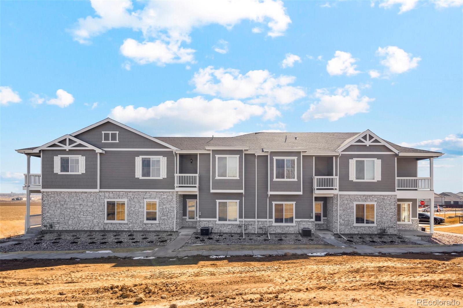 163 Robin Road Johnstown, CO 80534 - Photo 12 of 24 a front view of a house with a yard