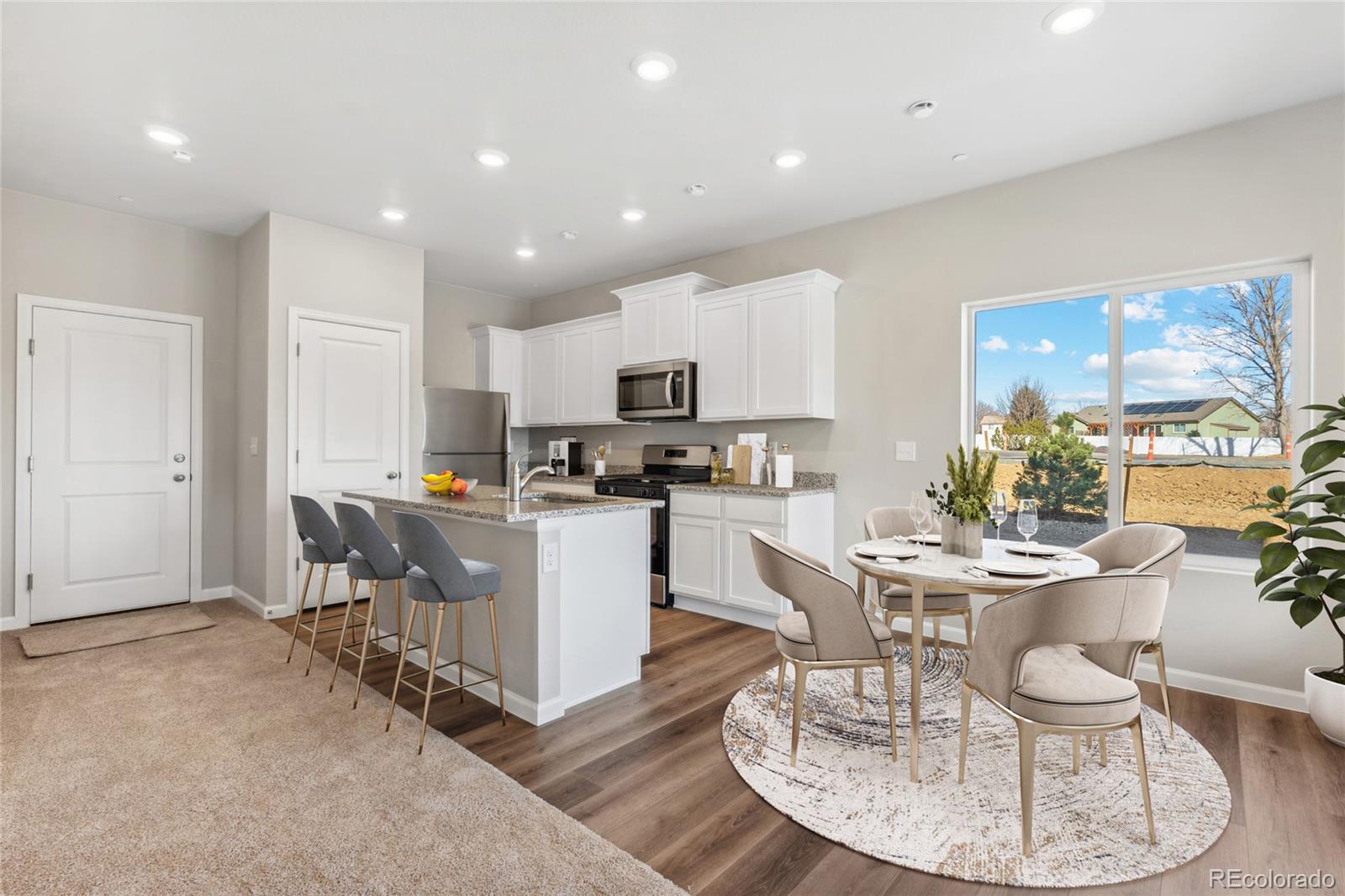 163 Robin Road Johnstown, CO 80534 - Photo 4 of 24 a kitchen with a dining table chairs and refrigerator