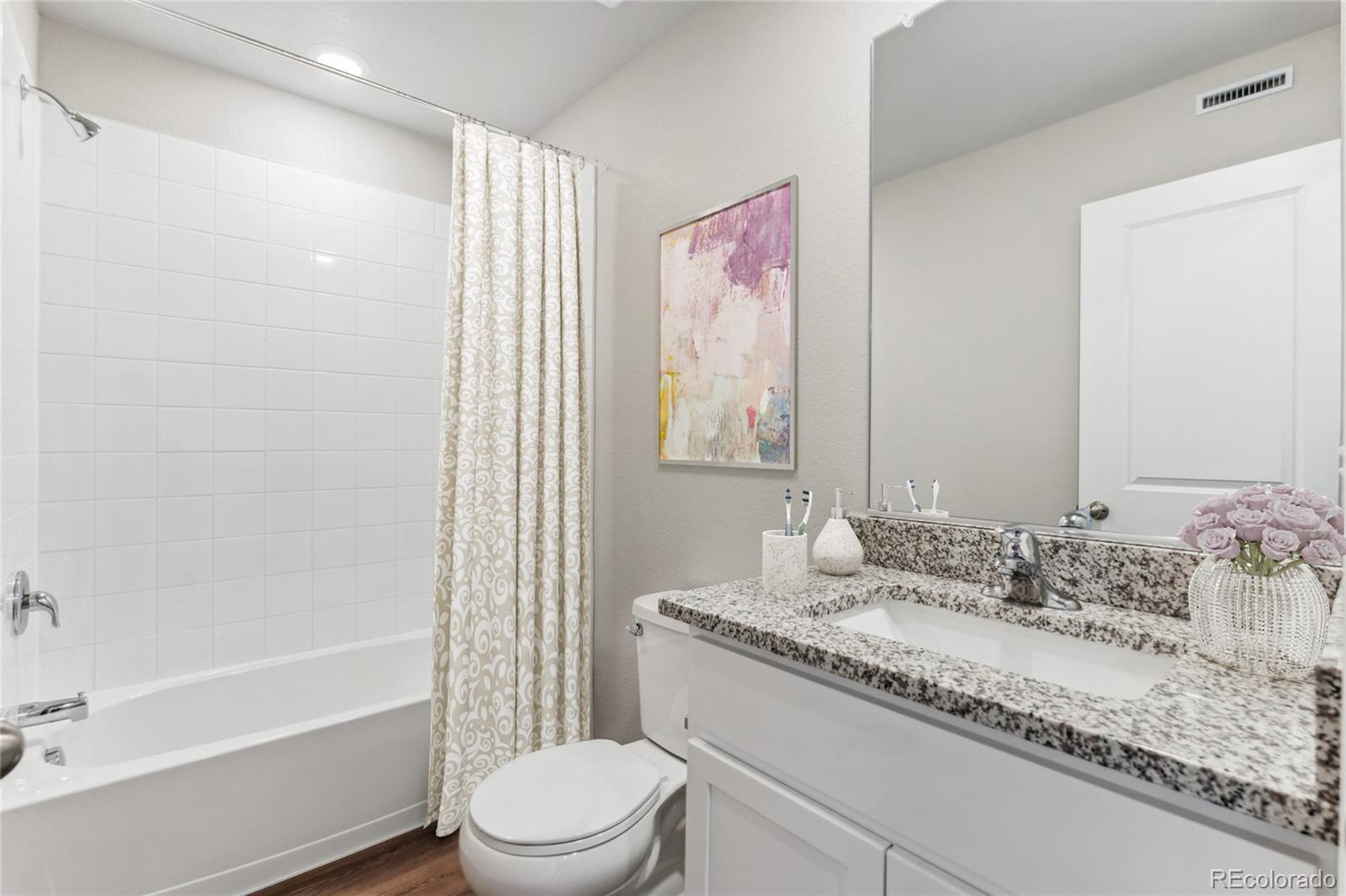 163 Robin Road Johnstown, CO 80534 - Photo 7 of 24 a bathroom with a granite countertop sink a toilet and shower