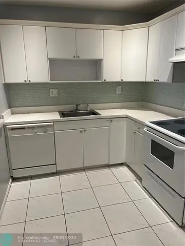 a kitchen with cabinets and appliances