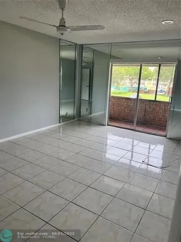 en empty room with sliding door and mountain view